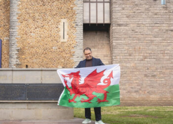 Ammar Akhtar, founder and CEO of Final Rentals, holding a Welsh flag