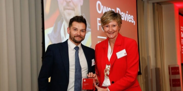 Owen Davies receives the Finance Impact Award from ACCA president Melanie Proffitt